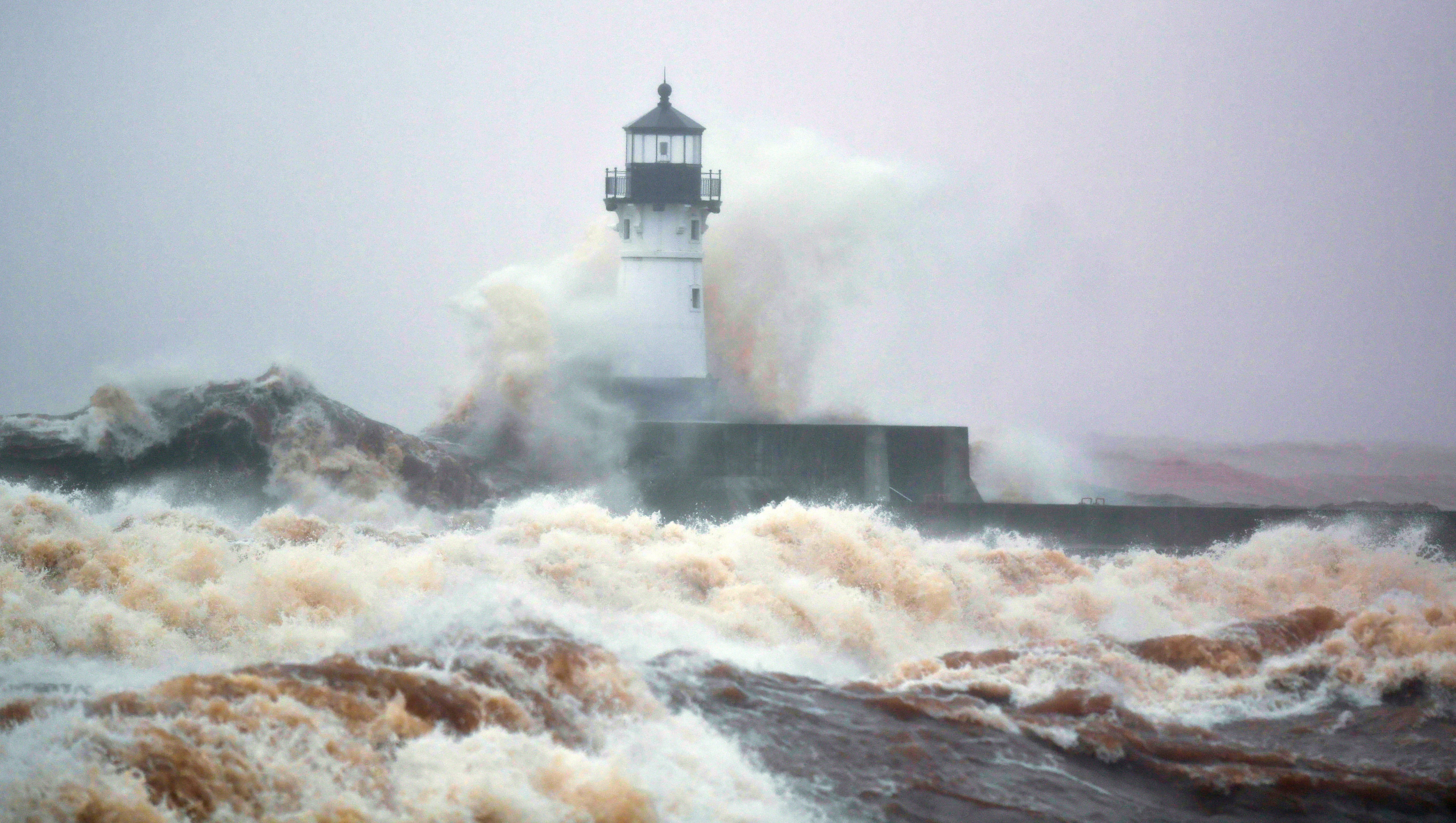 The Duluth lighthouse on a very stormy day with waves as tall as the lighthouse