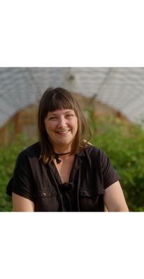 Teresa Bertossi in front of a greenhouse